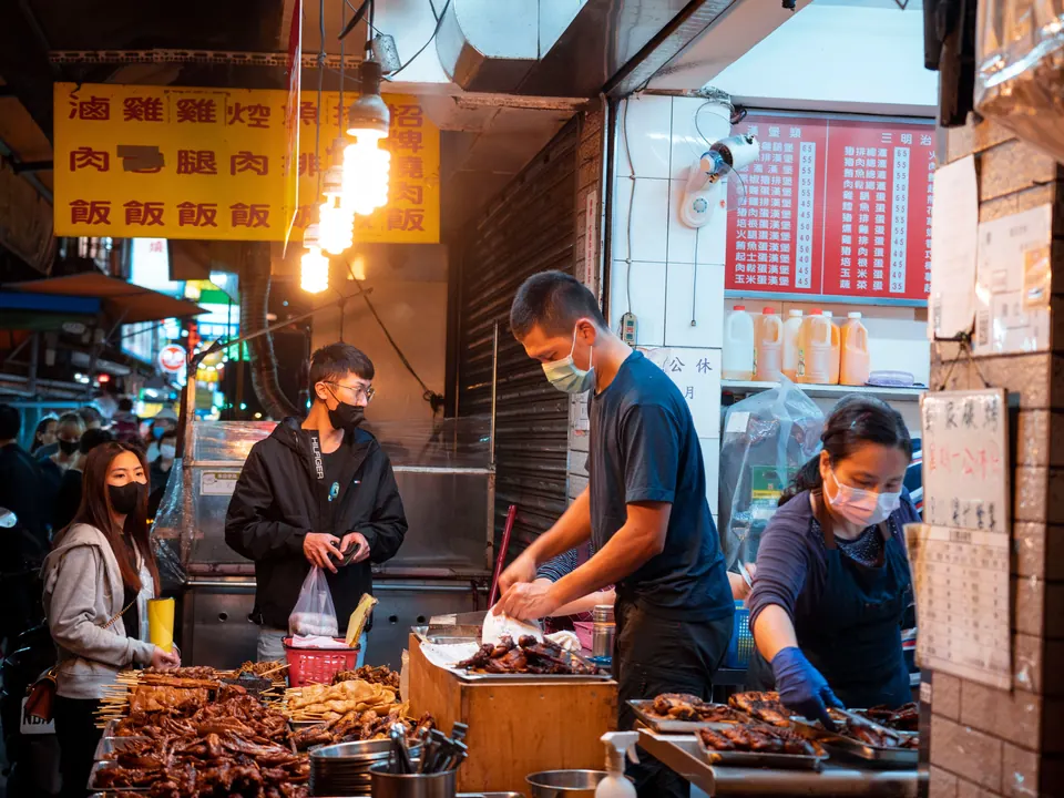 A carefully presented food stall at night